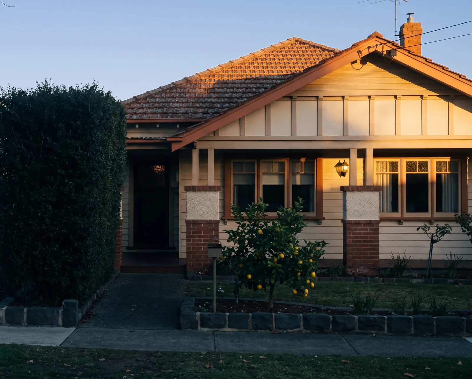 A brick Californian bungalow in late afternoon light