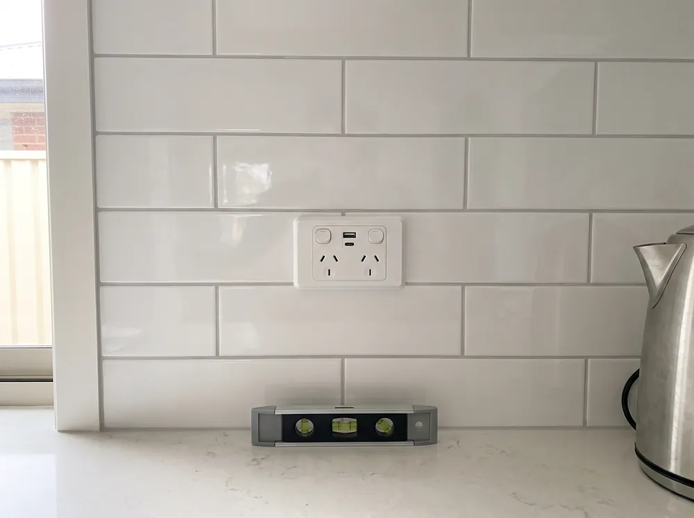 A double power point being fixed to a wall